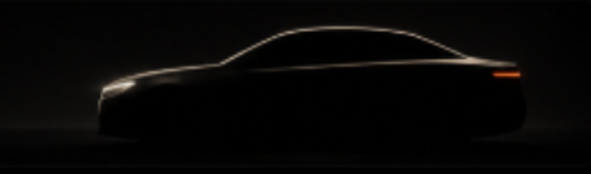 Dark executive car outlined by soft light